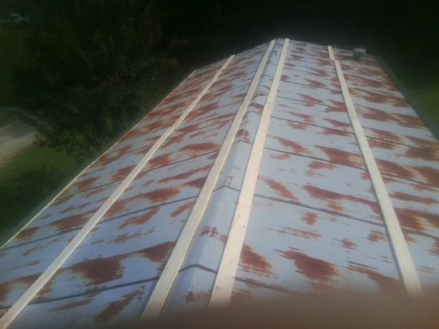 Rusted metal roof panels with new wood purlins before replacement — Storm Damage Roof Repair in Mottville by Roofing Brothers